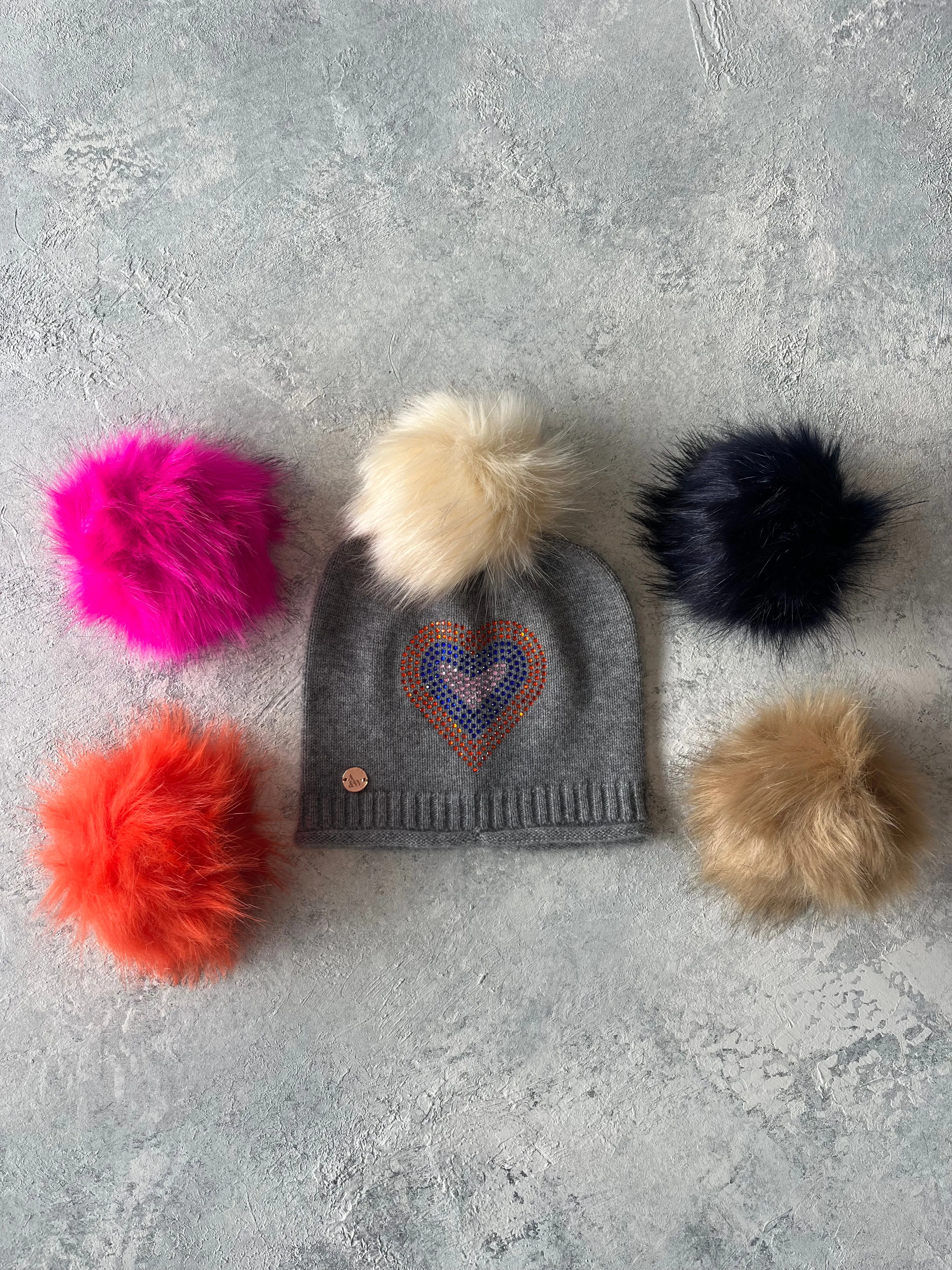 Grey cashmere plain knit beanie with heart embellishment & faux fur pom